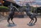 Bronze statues of two stallions rearing on their hind legs in combat at an empty shopping center in Arlington, Texas.