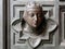 Bronze woman`s head wearing the crown â€“ door decoration of Santa Maria del Fiore cathedral, Florence, Italy