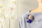 Brooch handmade in the form of flowers beige and blue color is attached to the female blouse