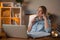 Brooding businesswoman sits at her office with pen near the table with documents and laptop. Modern office. Online learning