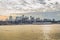 Brooklyn Borough Cityscape at Sunset. Beautiful Colors Reflected in the River and the Clouded Sky in New York City