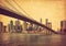 Brooklyn Bridge and Lower Manhattan  in New York City, United States. Photo in retro style. Added paper texture