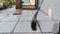 A broom made of wooden handle on the floor leaned against the wall.