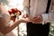 Broom putting on a golden wedding ring to a tender bride finger