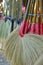 Brooms hanging for sale in the market.