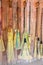 Brooms for sale - variety of decorative brooms that look like they are made for witches and wizards and flying hanging against