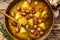 Broth Split pea soup with smoked sausages in a wooden plate. wooden background. Top view