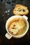 Broth with toasts of bread and black olives