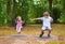 Brother and baby sister on swing on playground