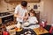 Brother with his little sister preparing food on kitchen and have fun