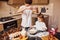 Brother with his little sister preparing food on kitchen and have fun