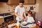 Brother with his little sister preparing food on kitchen and have fun