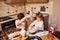 Brother with his little sister preparing food on kitchen and have fun