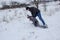 Brother playing in winter with younger brother,older brother pushes little boy into snow