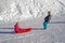 Brother pulling his sister kids toboggan sled snow. Little girl and boy enjoying sleigh ride. Child sledding. Children