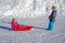 Brother pulling his sister kids toboggan sled snow. Little girl and boy enjoying sleigh ride. Child sledding. Children