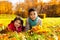 Brother and sister on autumn lawn