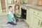 Brother and sister baking cookies in the oven in the kitchen