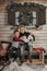 Brother and sister on a bench in front of the house in winter