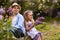 Brother and sister in the botanical garden in spring where flowers bloom