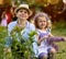 Brother and sister in the botanical garden in spring where flowers bloom