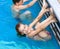 Brother sister doing exercises in pool