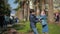 Brother and sister fights and pushes each other in the street against the backdrop of palm trees