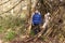 Brother and sister in a forest shelter made of tree branches