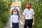 Brother and sister go to school in protective masks .