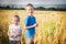 Brother and sister in golden wheat field