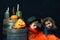 Brother and sister on Halloween. Funny kids in carnival costumes on dark background .