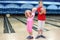 Brother and sister hold balls in bowling club