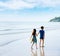 Brother sister holding hand walk on the beach