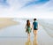 Brother sister holding hand walk on the beach