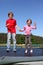 Brother and sister jump on trampoline