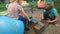 A brother and sister playing with builders bricks and putty