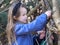 Brother and sister playing in their den in the woods with branches