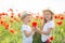 Brother and sister in poppy field