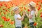 Brother and sister in poppy field