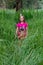 The brother and sister run through the tall grass