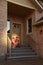 Brother and sister sit on stairs near door