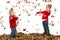 Brother and Sister Throwing Leaves