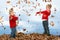 Brother and Sister Throwing Leaves