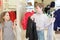 Brother with sister trying on clothes in store