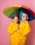 Brother and sister under one umbrella. Children girl and boy in one yellow rain coat. Sale discount. Two in one