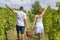 Brother and sister working on grape picking and holding the bask