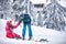 Brother teaches for his sister to ski on snow outdoor in sunny d