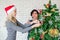 Brothers help each other decorate the Christmas tree