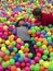 Brothers lays on the big heap of multicolored small balls.