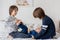 Brothers, playing at home, tickling feet laughing and smiling